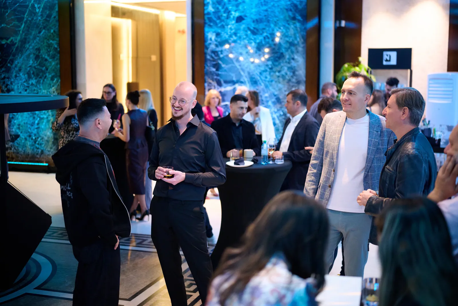 Guests laughing in the packed lounge at The N-Space