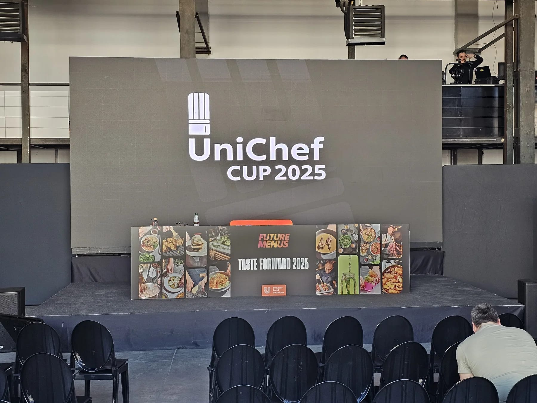 UniChef Cup 2025 stage in Bucharest with central event branding and product displays.