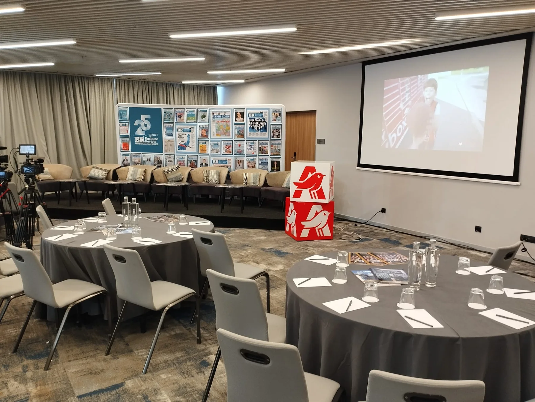 Business Review conference room at Courtyard by Marriott in Bucharest with projection, stage seating and a speaker.