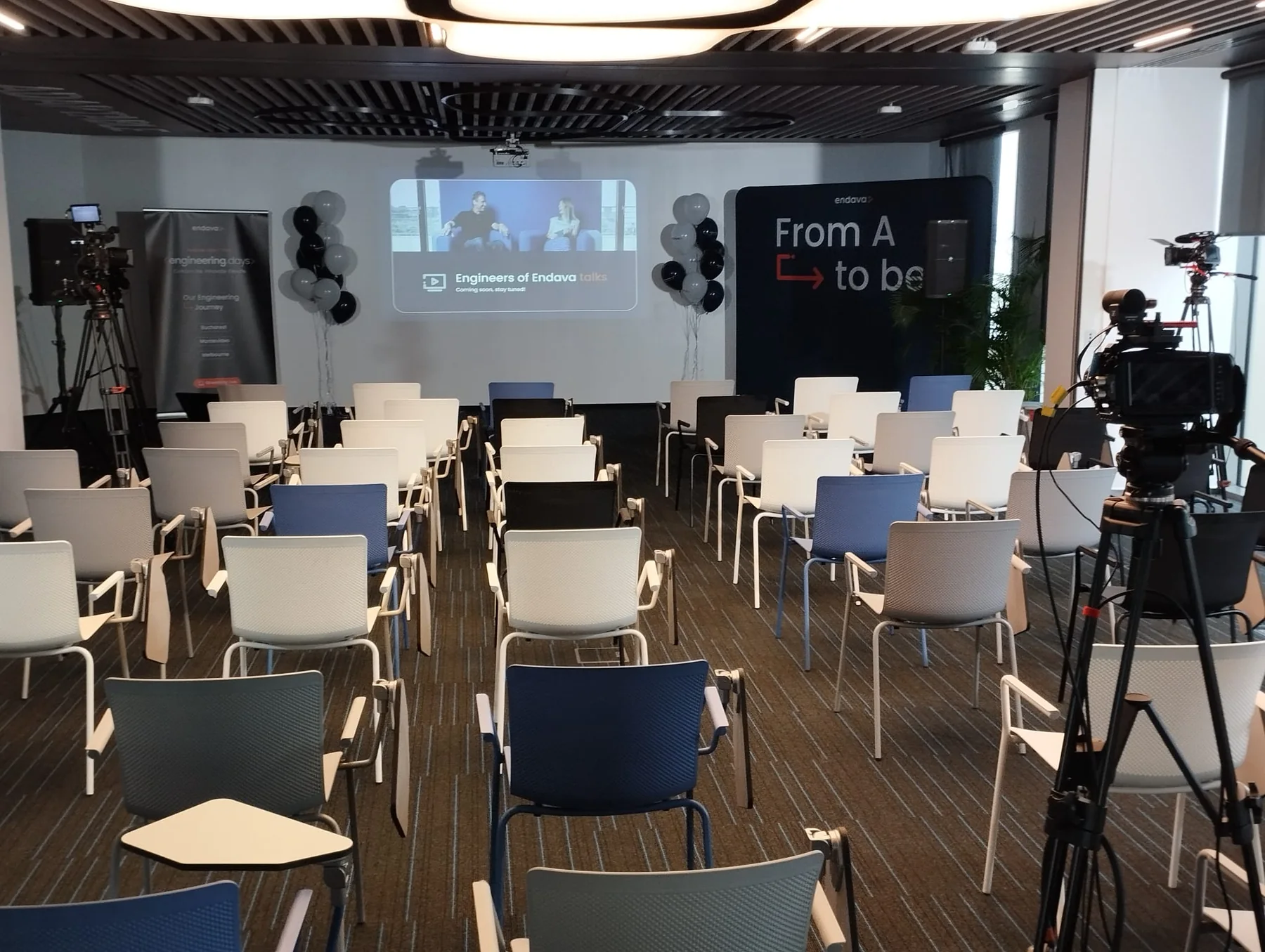 Endava internal event at U Center in Bucharest with camera, projection screen, stage seating and technical production.