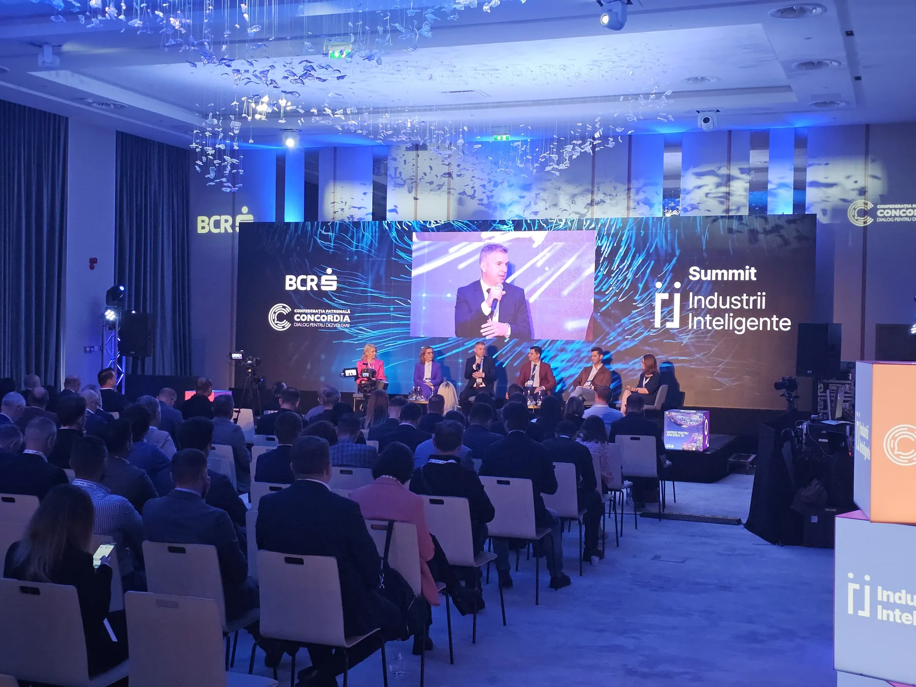 Audience facing the Smart Industries Summit LED stage at Radisson Blu in Cluj-Napoca.