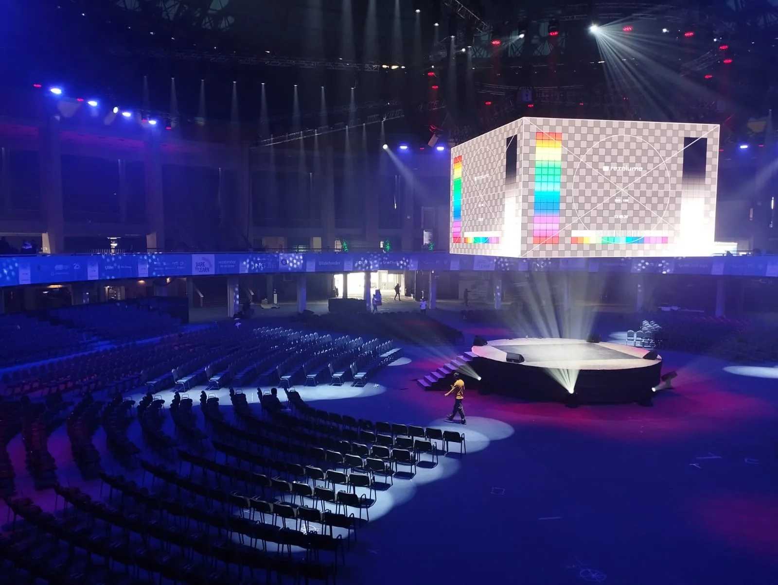Dare to Learn event hall at Romexpo in Bucharest with stage, suspended display and audience seating.