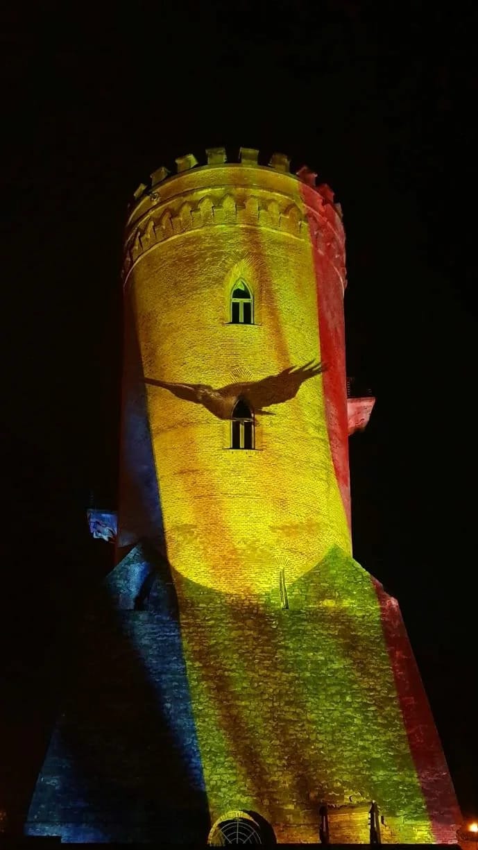 Close portrait view of dynamic projection across the tower facade at Turnul Chindiei.