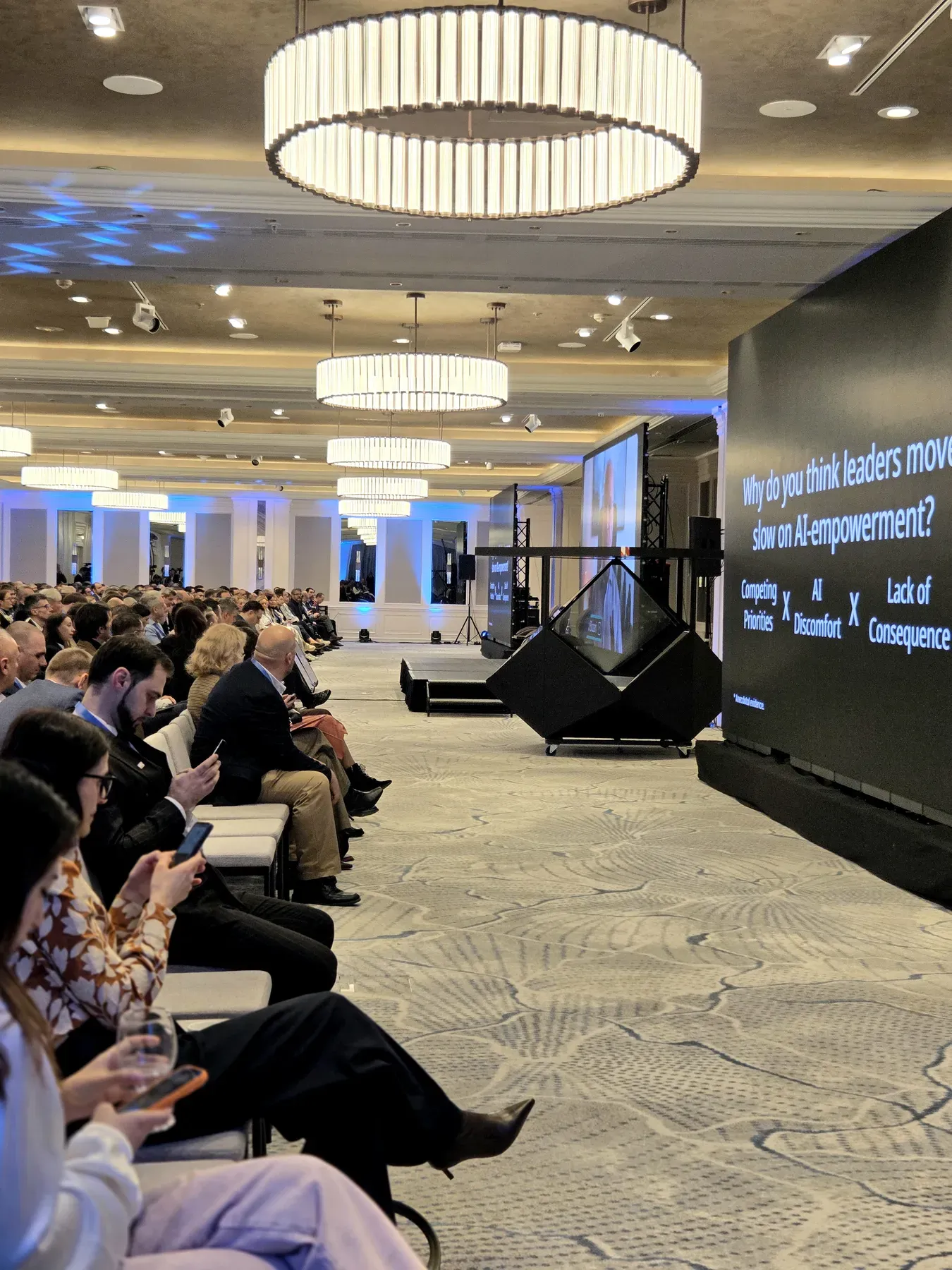 Dreamoc Diamond holographic display positioned beside the presentation screen during the AmCham event in Bucharest.