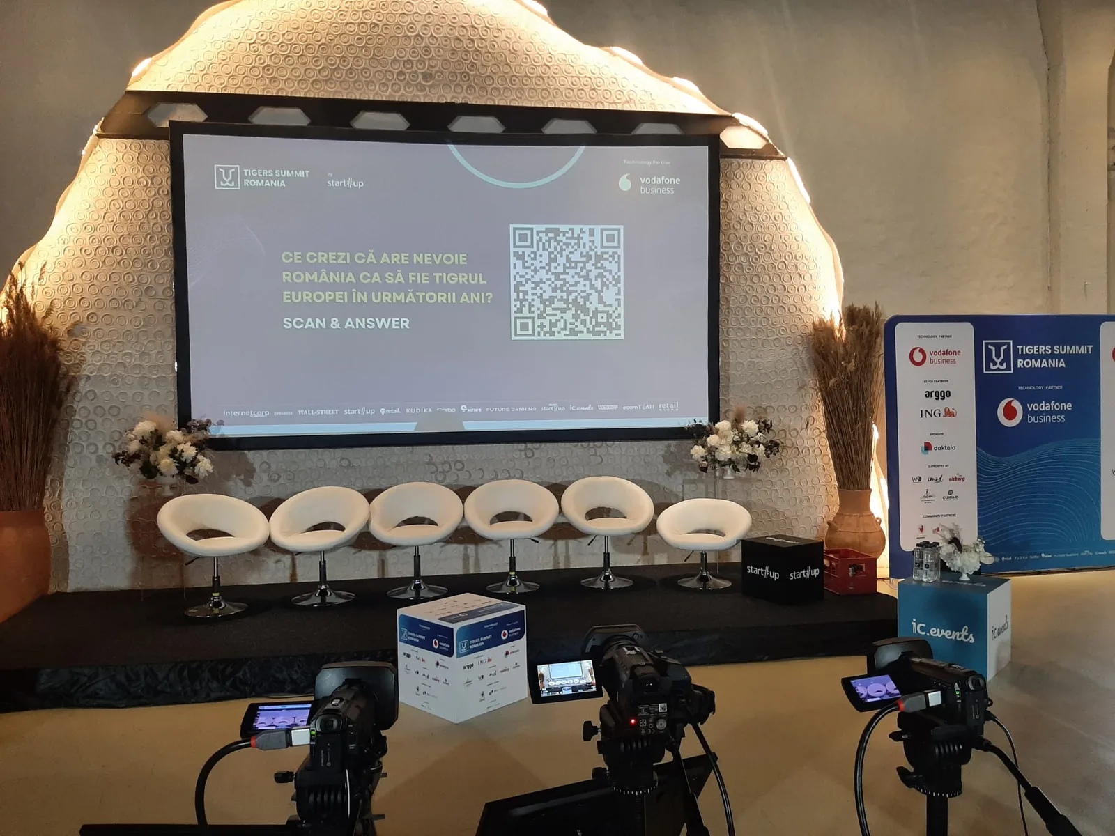 Live streaming camera setup facing the presentation screen during a Business Review conference at Pentagon Events in Bucharest.