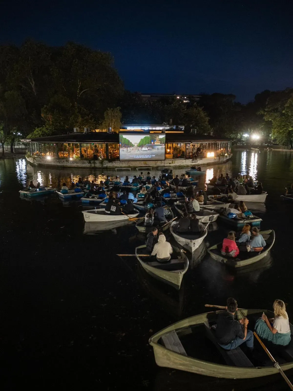 Guests seated outdoors during the large-format projection event for Blue Restaurant in Bucharest.