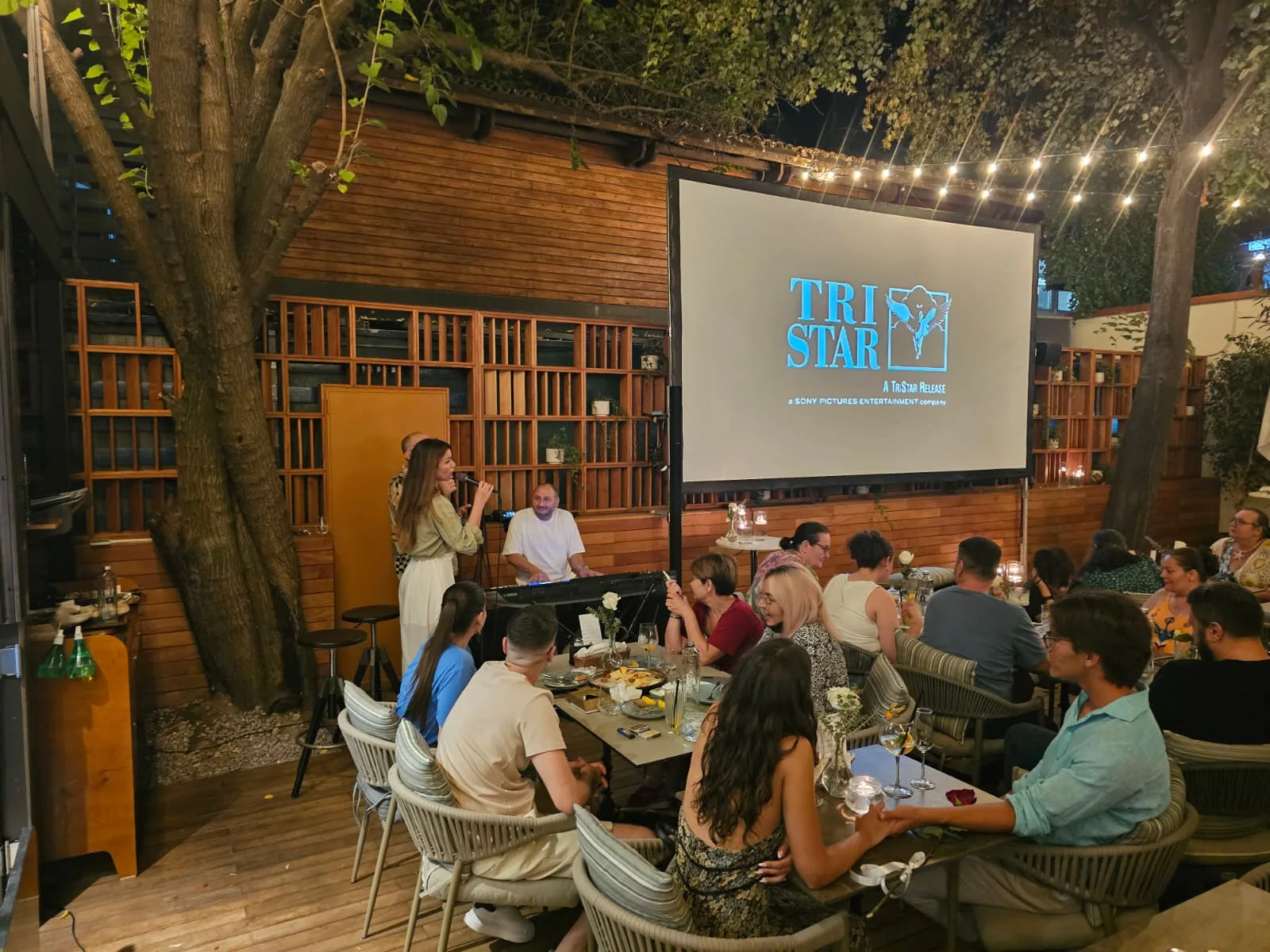 Large outdoor projection screen showing film content during the Blue Restaurant event in Bucharest.