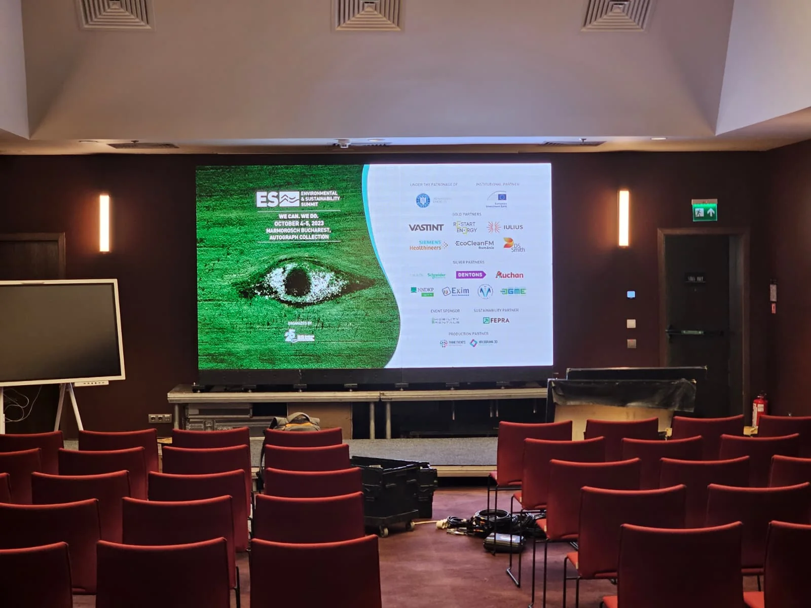 Conference screen and room setup for the live-streamed Business Review event at Hotel Marmorosch in Bucharest.