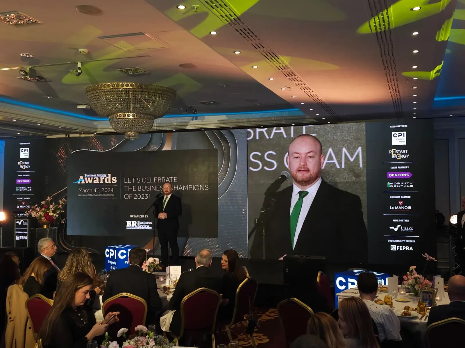 Audience facing the LED stage during the Business Review conference at Grand Hotel Marriott in Bucharest.
