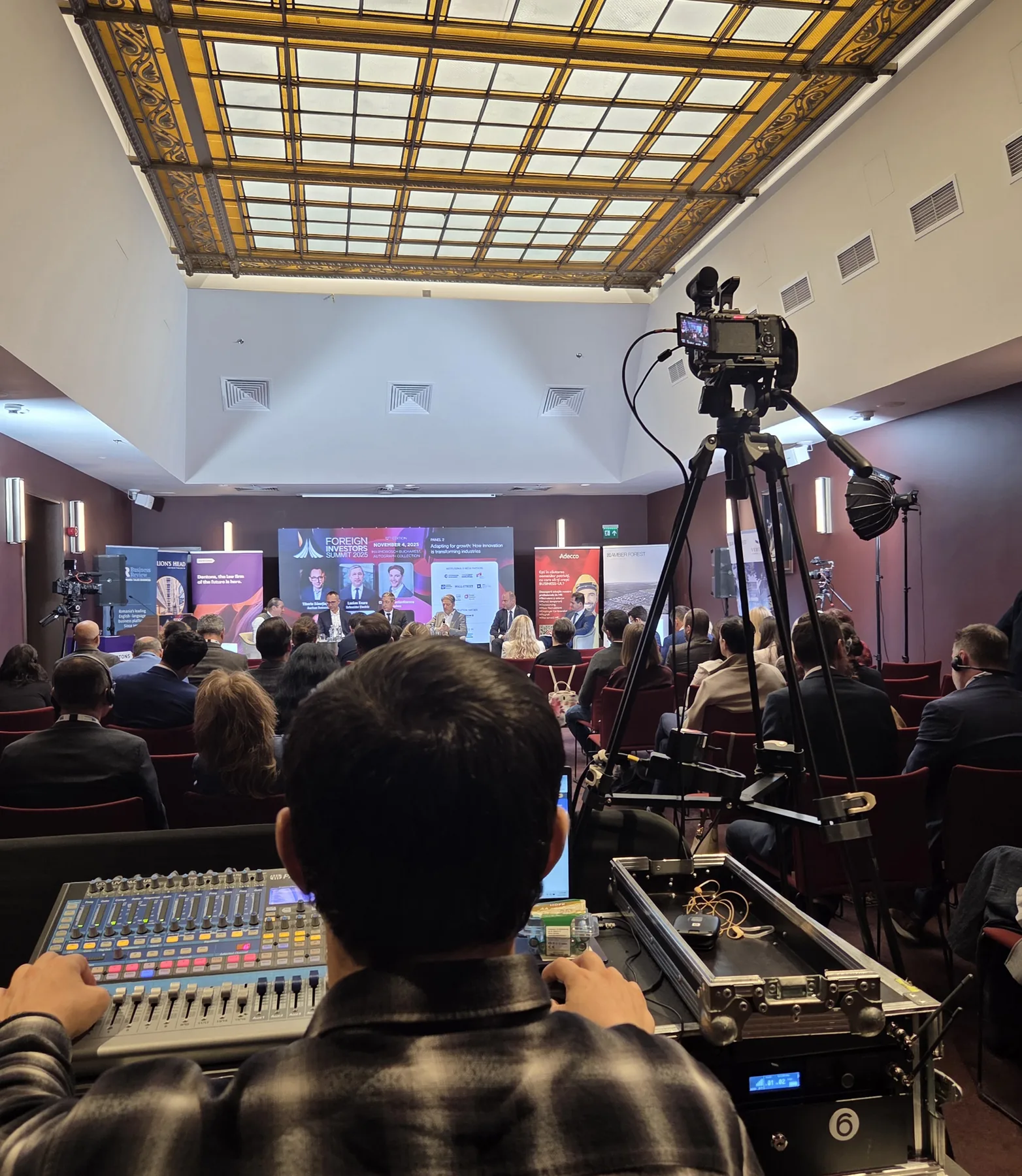 Audience view, camera tripod and live production control desk during the Business Review Foreign Investors Summit 2025 at Hotel Marmorosch in Bucharest.