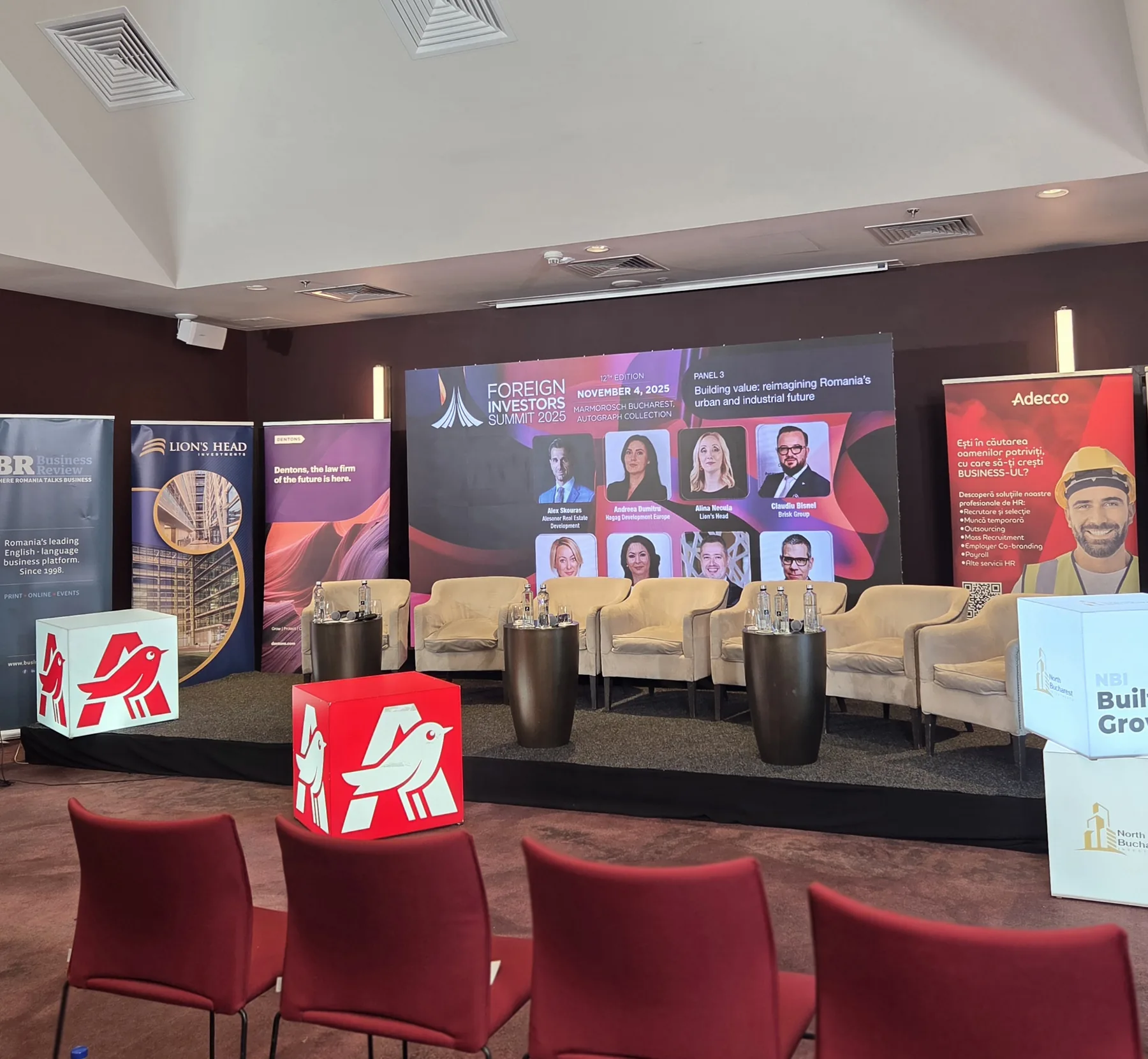 Stage seating, LED backdrop and branded cubes for the Business Review Foreign Investors Summit 2025 at Hotel Marmorosch in Bucharest.