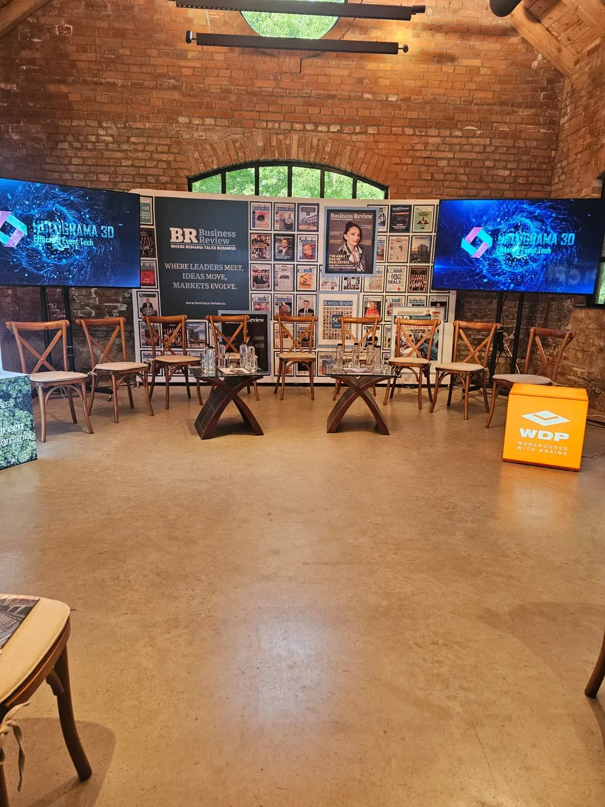 Professional displays and branded stage setup for the Business Review conference at Caro Atelier in Bucharest.