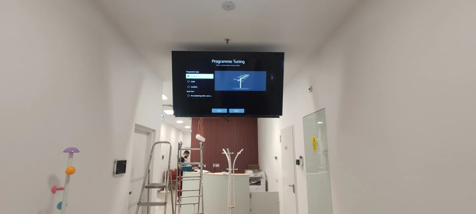 Wall-mounted professional display installed for digital signage inside the Digestmed clinic in Bucharest.