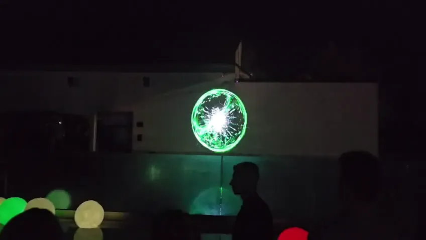 Green circular videomapping graphic projected across the exterior event facade during the EveryMatrix Danube Delta experience in Tulcea.