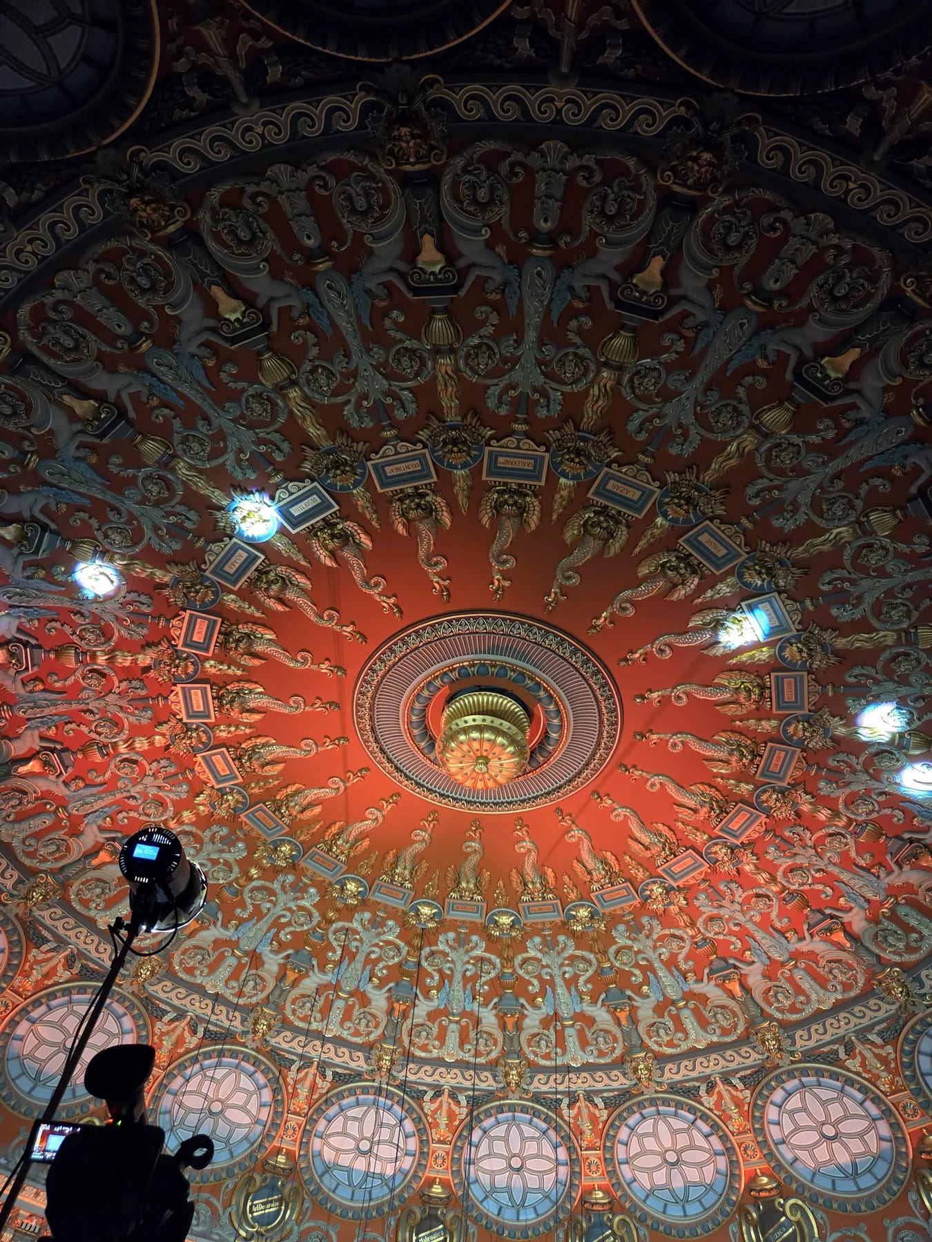 Ornate Romanian Athenaeum ceiling and event lighting above the European Roma Institute programme in Bucharest.