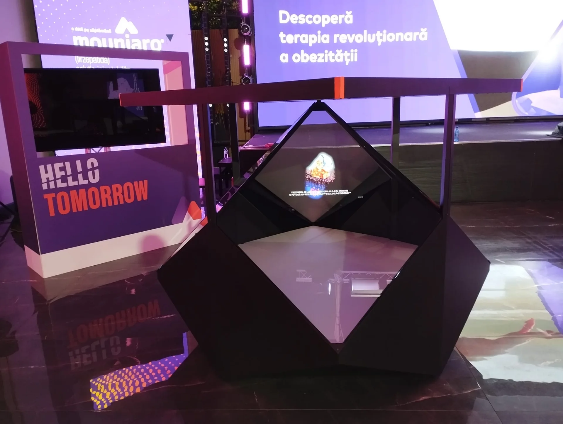 Dreamoc Diamond holographic display positioned in front of the Eli Lilly event stage at Face Club in Bucharest.
