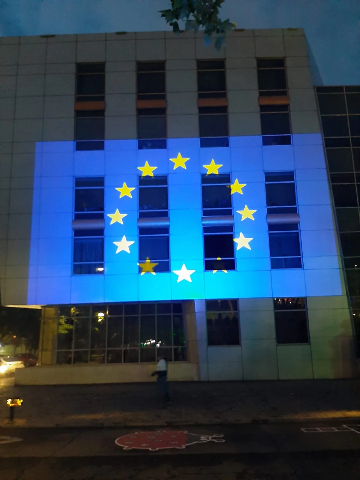 Europe Day projection of the European Union flag and stars on the Sector 2 City Hall building in Bucharest.