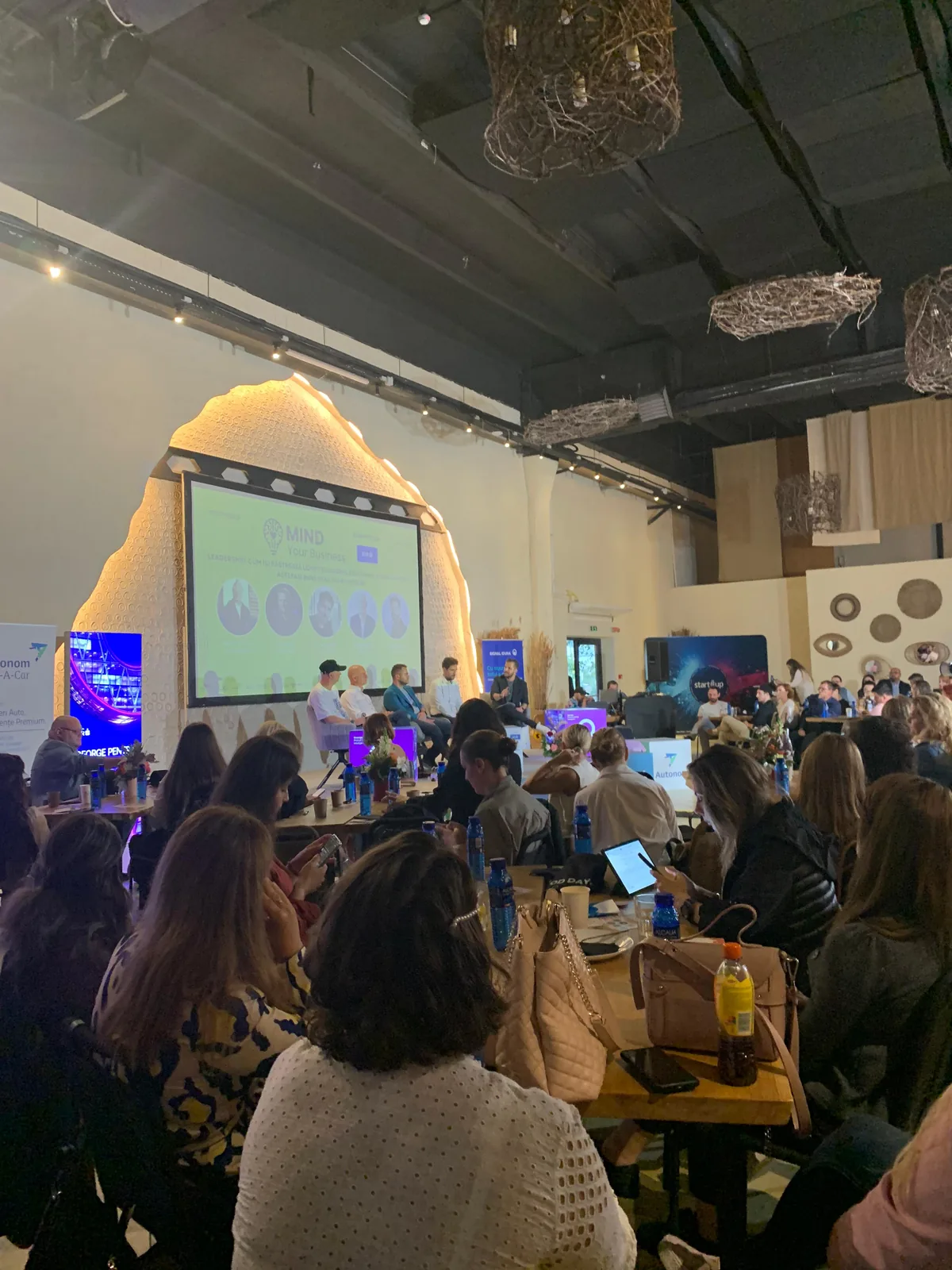 Guests attending the Mind Your Business event at Nayam with the projection setup visible at the front of the room.