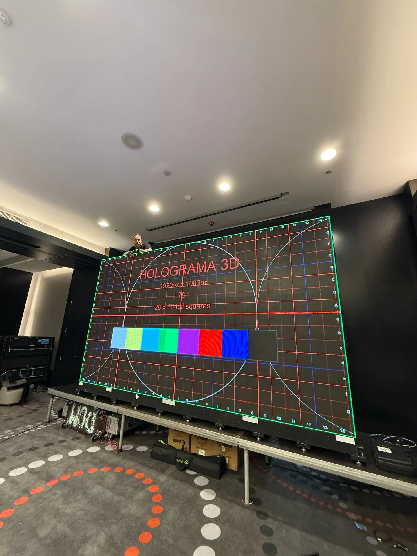 Technician testing the LED wall with a 1920 × 1080 calibration pattern before the Digital Banking Scorecard event at Sheraton Bucharest.