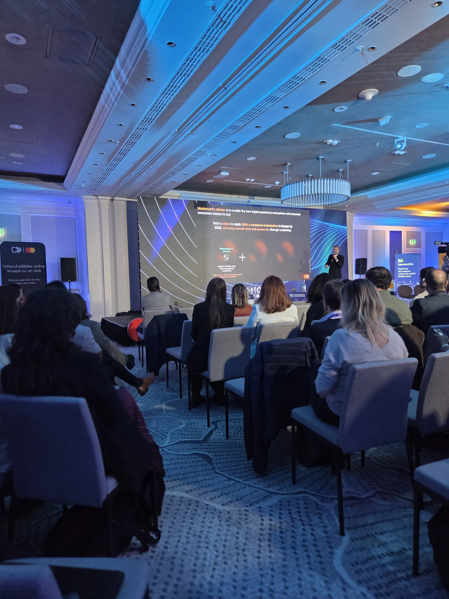 Conference audience facing the Netopia stage and presentation screen at Marriott Bucharest.