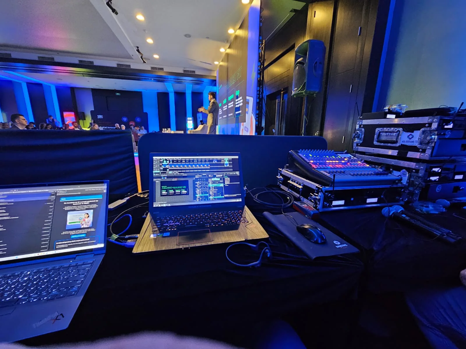 Technical control position with laptops, audio mixer and stage view during Digital Banking Scorecard at Sheraton Bucharest.
