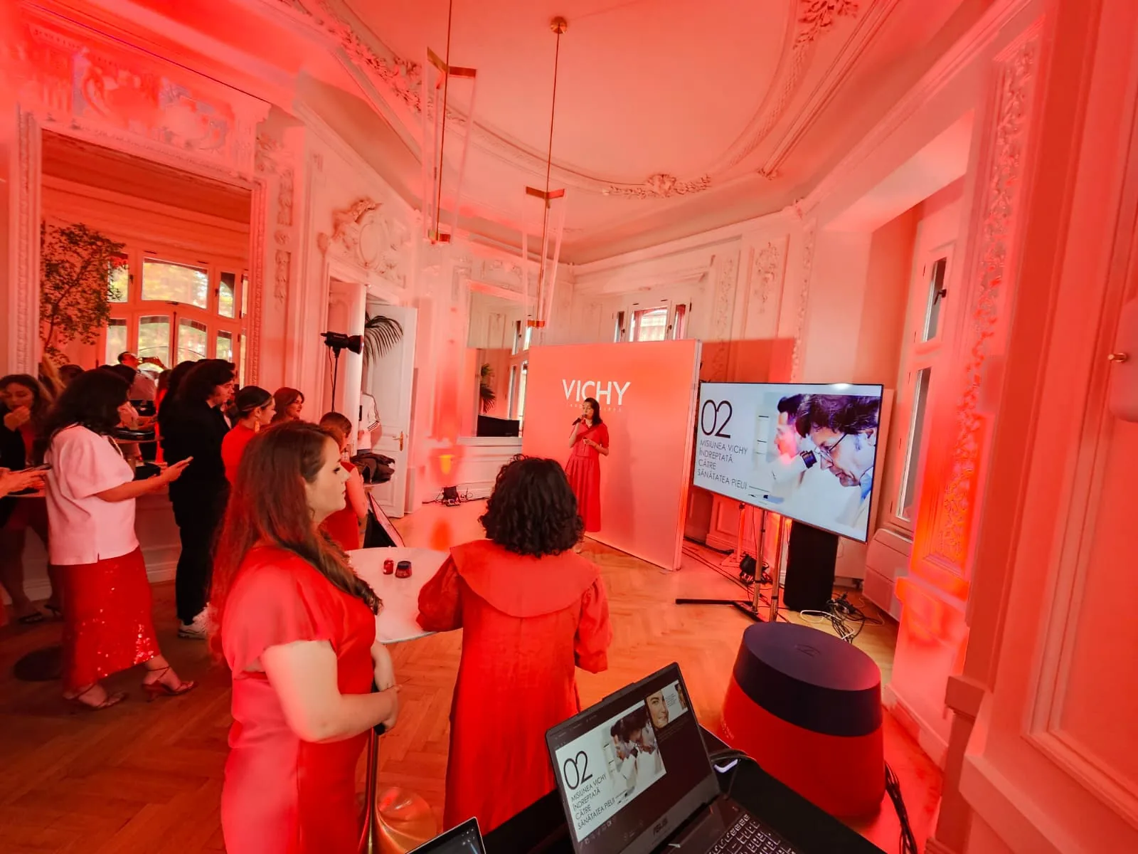 Vichy event space at Mitza Biciclista with guests, a professional display and red ambient lighting in Bucharest.