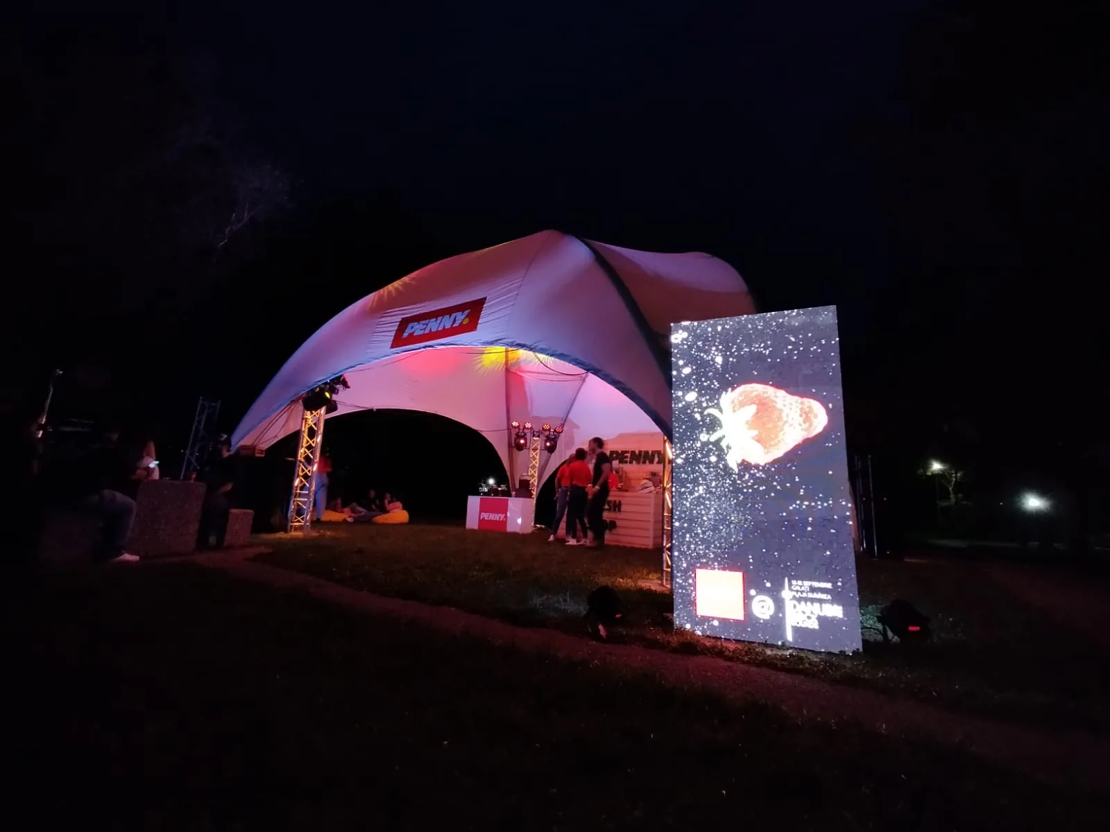 PENNY festival activation in Galati at night with the branded tent and illuminated digital display.