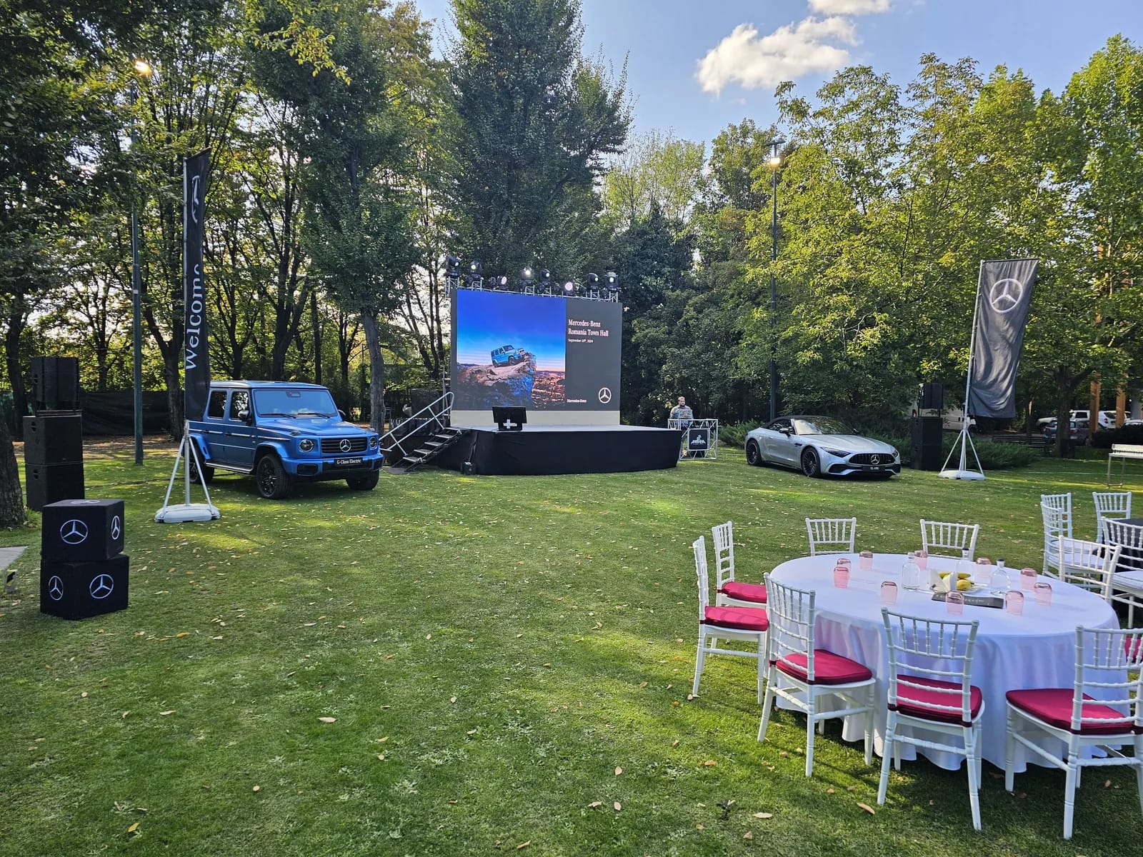Mercedes-Benz vehicles arranged around the outdoor LED screen and event area at Crowne Plaza in Bucharest.