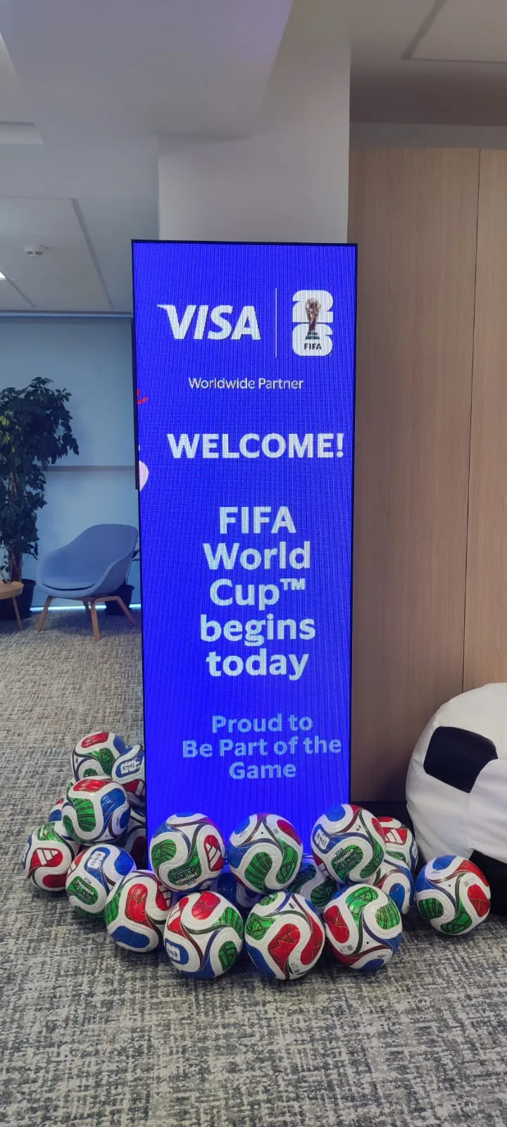 Visa-branded vertical digital poster inside the Visa office for Visa at Visa Office in Bucharest.
