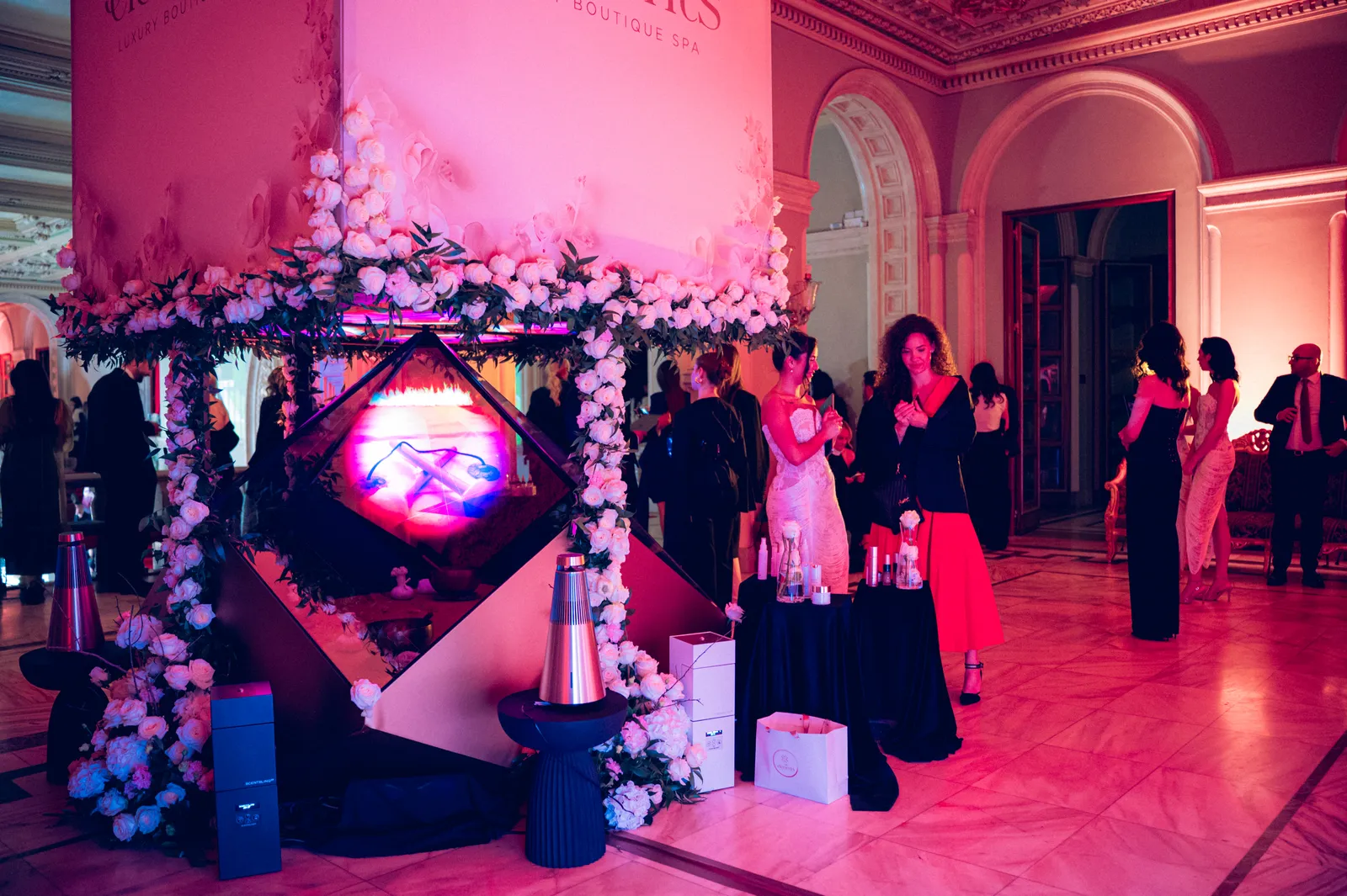 Guests around the Dreamoc Diamond under pink event lighting