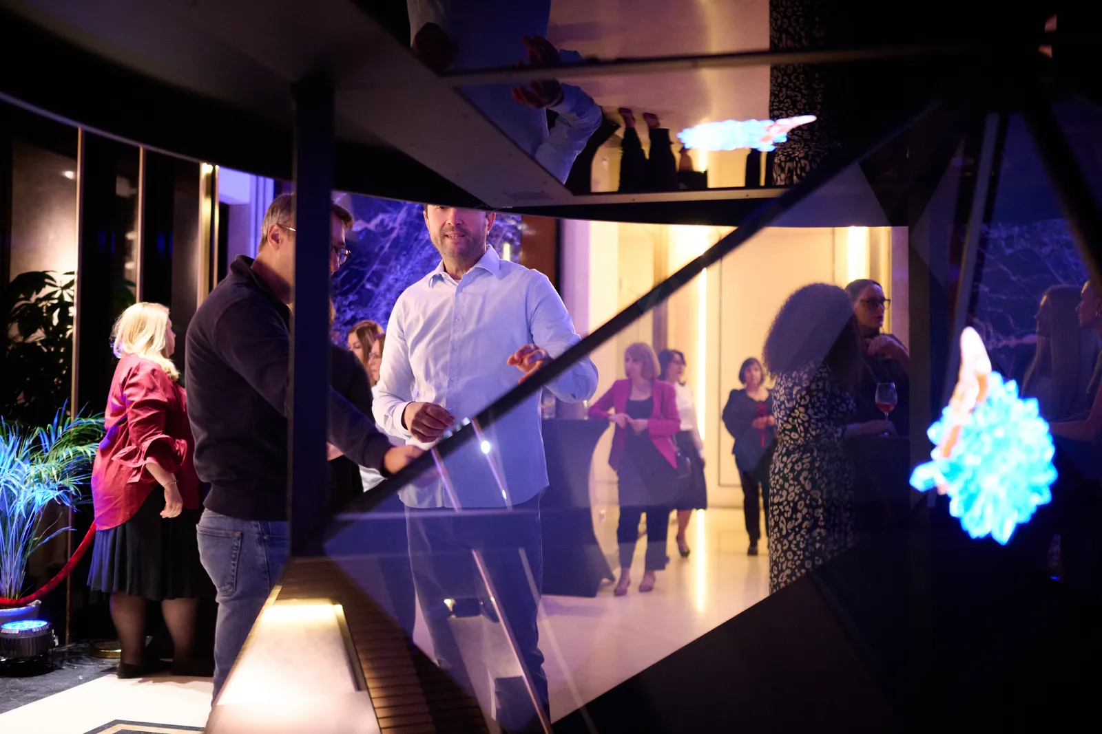 Holographic sparks in the Dreamoc Diamond as guests gather around